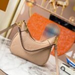 Louis Vuitton Monogram Empreinte Leather Bagatelle Mini Hobo In Beige