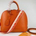 Louis Vuitton Epi Leather Alma PM Handbag In Orange With Jacquard Strap