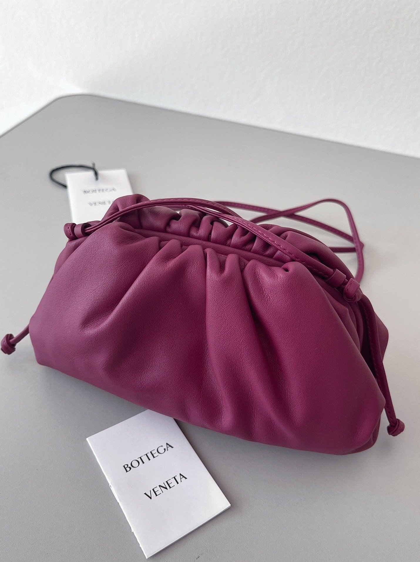 B2804780-E315-133D-7B15-16808AA81627.jpg Replica Bottega Veneta Mini Pouch with Strap Cinnabar - Image 1