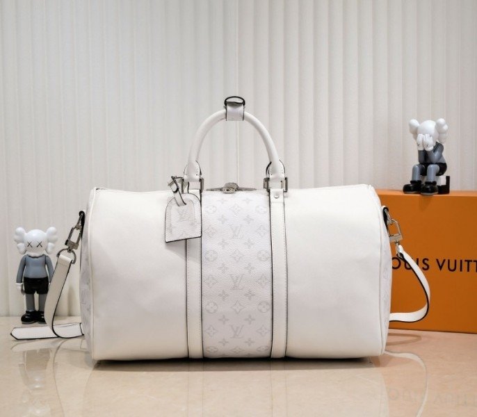 B6C4C0AA-8CB8-4D19-2436-3C32E4ABD16E.jpg Louis Vuitton Taiga Leather Keepall Bandouliere 50 Travel Bag In White - Image 1