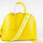 Louis Vuitton Epi Leather Alma PM Handbag In Cedrat Yellow With Jacquard Strap